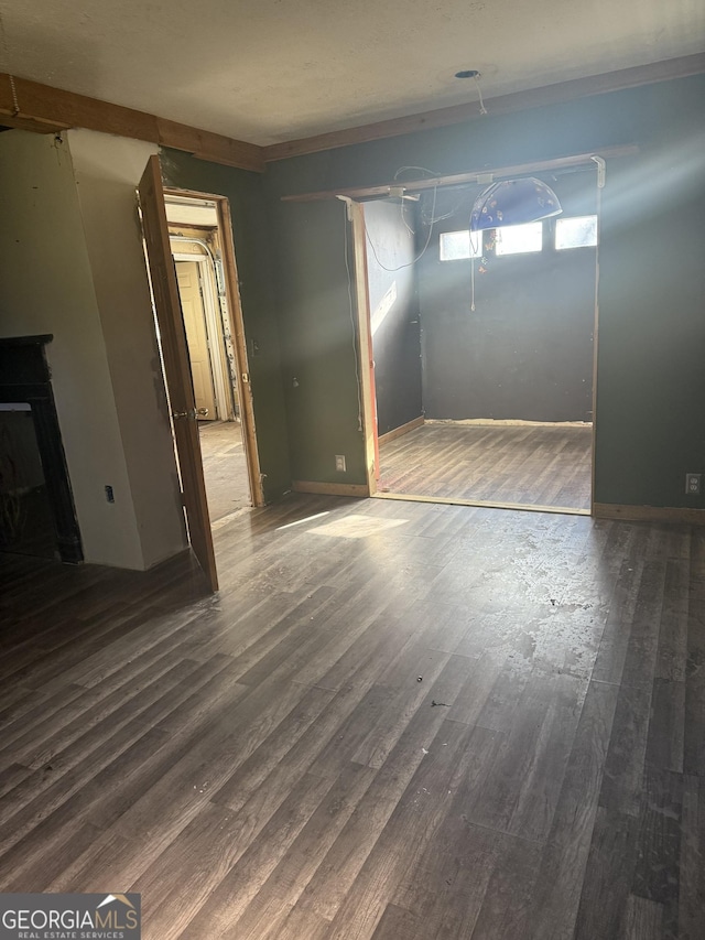 unfurnished living room featuring dark hardwood / wood-style floors