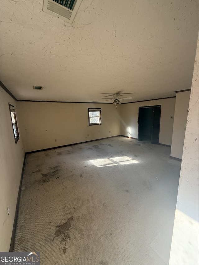 unfurnished room featuring ceiling fan and carpet