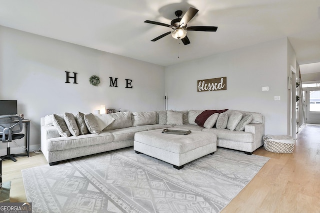 living room with hardwood / wood-style floors and ceiling fan