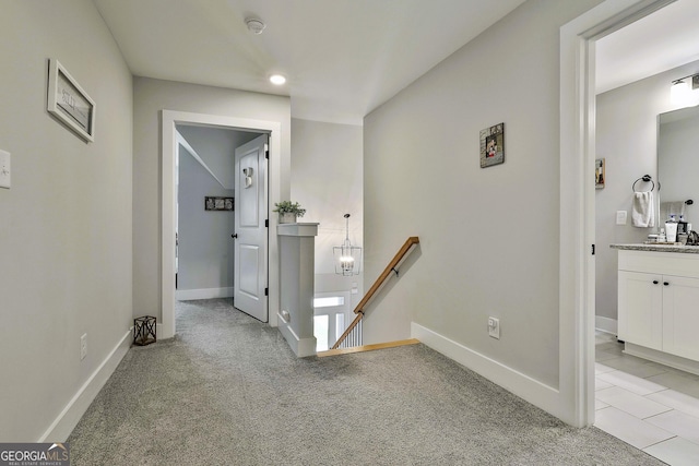 hall featuring light colored carpet