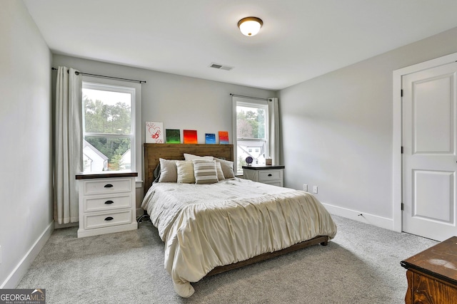 carpeted bedroom with multiple windows