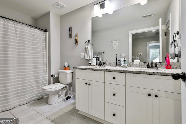 bathroom with tile patterned flooring, vanity, and toilet