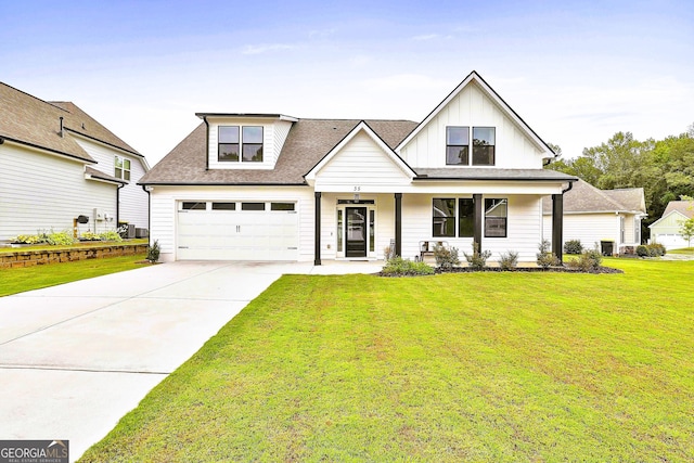 modern farmhouse featuring a front lawn, a porch, and a garage