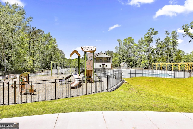 view of jungle gym featuring a lawn and a community pool