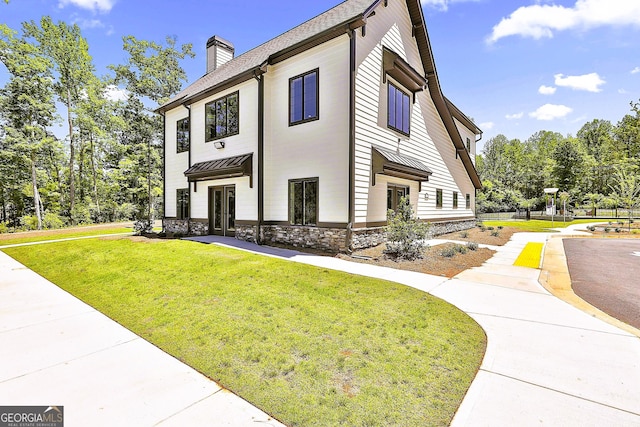 view of side of home featuring a yard