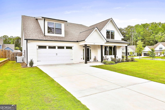 view of front of house with covered porch, a garage, central AC, and a front lawn