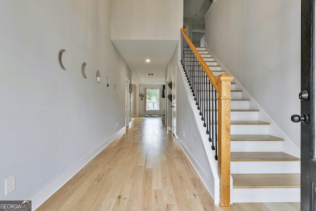 staircase with hardwood / wood-style floors