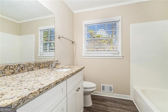 full bathroom with vanity, crown molding, hardwood / wood-style flooring, toilet, and shower / bath combination