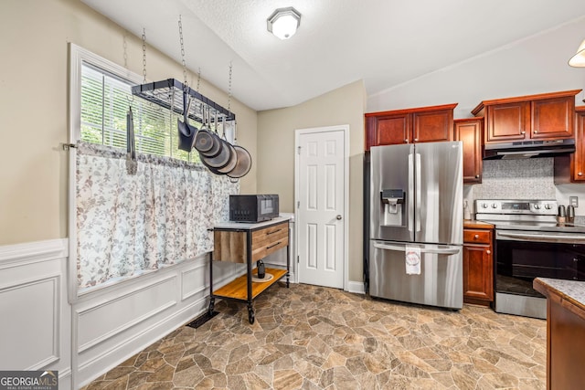 kitchen featuring backsplash, lofted ceiling, stainless steel appliances, and a textured ceiling