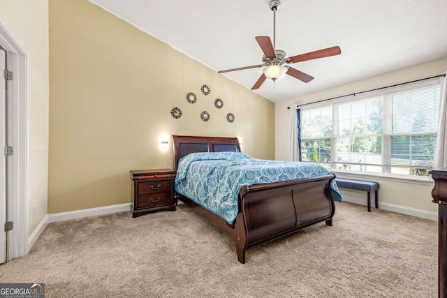 bedroom with light colored carpet, vaulted ceiling, and ceiling fan