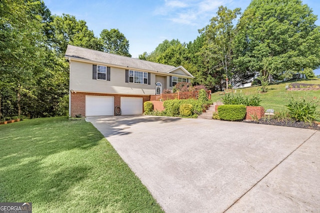 bi-level home with a garage and a front lawn