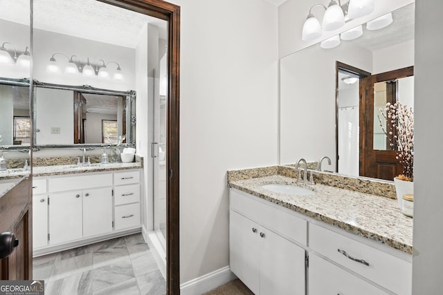 bathroom featuring a textured ceiling and vanity