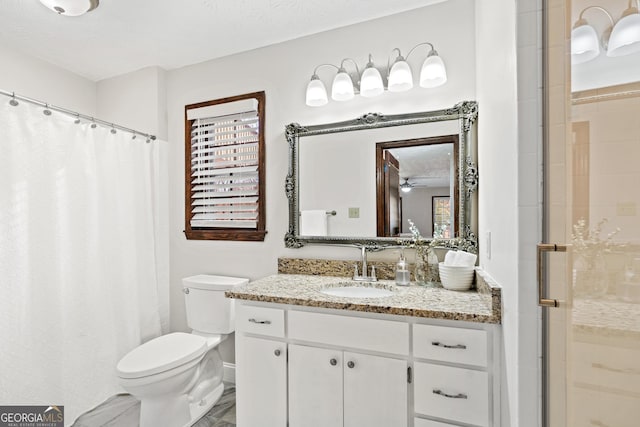 bathroom featuring ceiling fan, toilet, a textured ceiling, vanity, and a shower with shower curtain