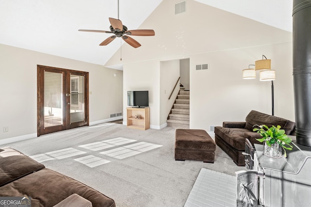 living room with light colored carpet, high vaulted ceiling, ceiling fan, and french doors