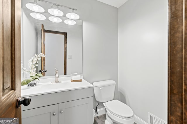 bathroom featuring toilet and vanity