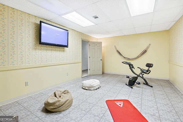 workout room with a paneled ceiling