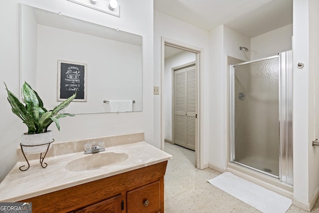 bathroom with a shower with door and vanity