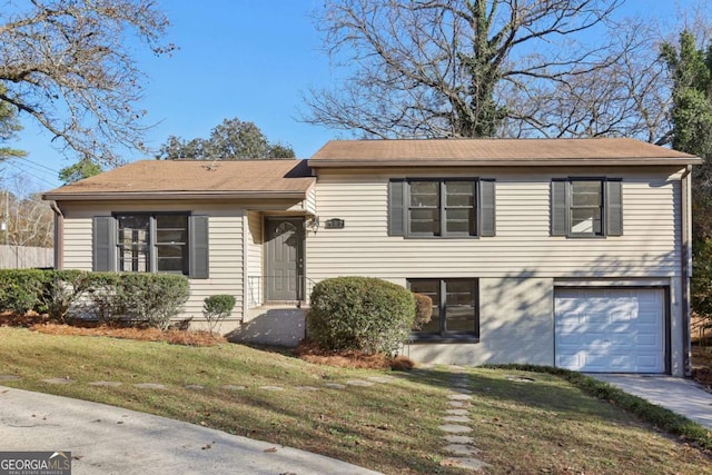 tri-level home with a garage and a front yard