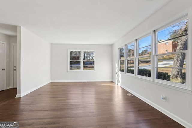 empty room featuring dark hardwood / wood-style flooring