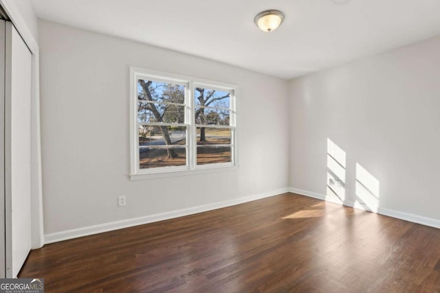 unfurnished bedroom with a closet and dark hardwood / wood-style flooring