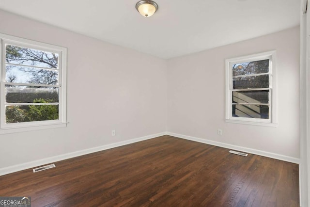 empty room with dark hardwood / wood-style floors