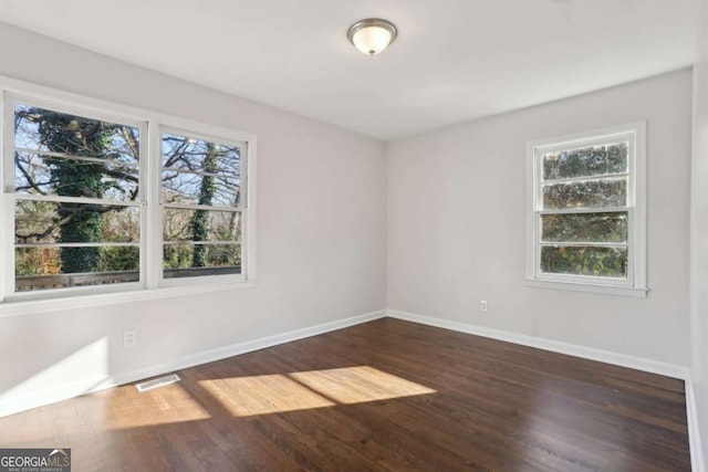 spare room with dark hardwood / wood-style floors