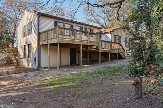 back of house with a wooden deck