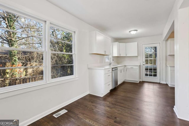 kitchen with white cabinetry, dishwasher, dark wood-type flooring, and sink