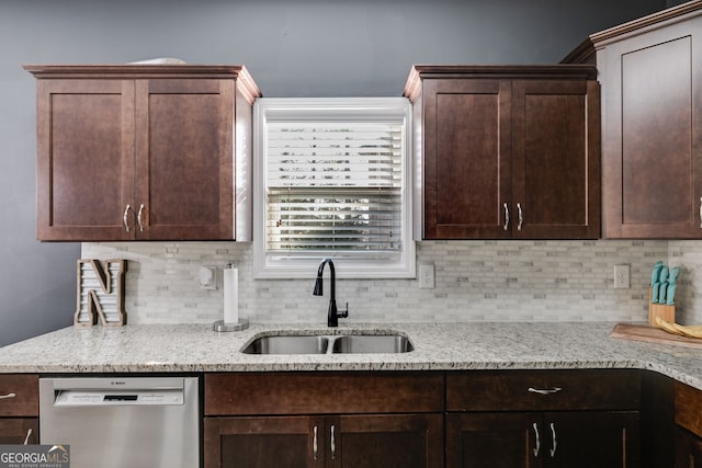 kitchen with light stone countertops, dishwasher, sink, tasteful backsplash, and dark brown cabinets