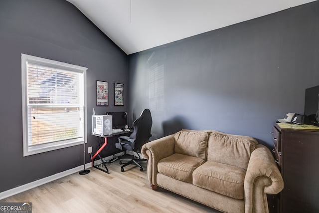 office area with light hardwood / wood-style floors, plenty of natural light, and lofted ceiling