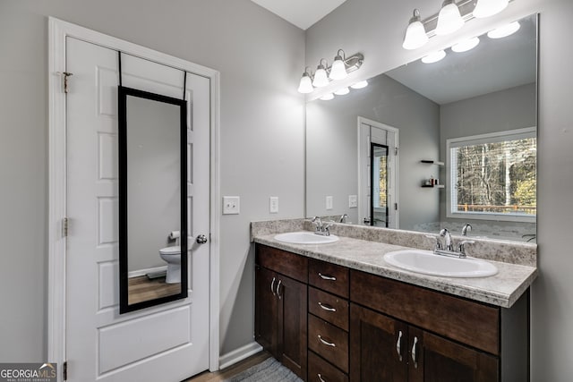 bathroom featuring vanity and toilet