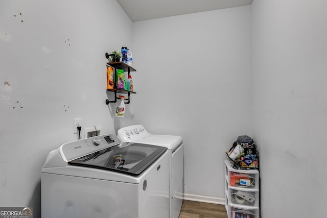 laundry area featuring hardwood / wood-style flooring and washing machine and clothes dryer