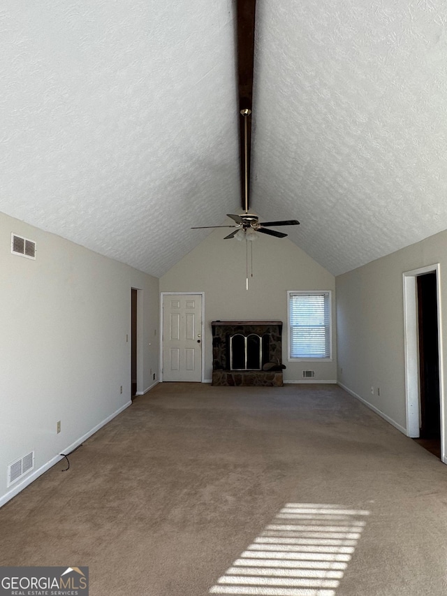 unfurnished living room featuring ceiling fan, a fireplace, a textured ceiling, vaulted ceiling, and light colored carpet