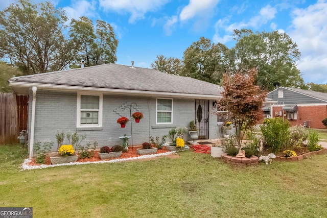 single story home featuring a front lawn