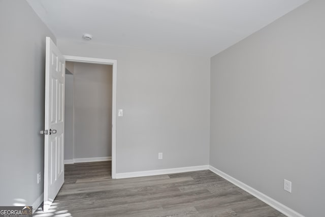 spare room with wood-type flooring