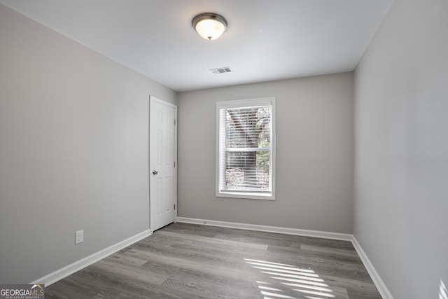 empty room with light hardwood / wood-style flooring