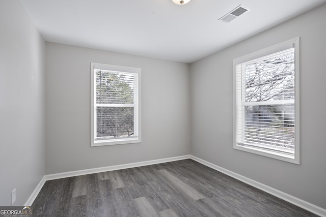 spare room with dark wood-type flooring