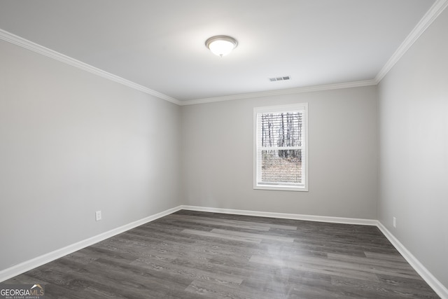 spare room with dark hardwood / wood-style flooring and ornamental molding