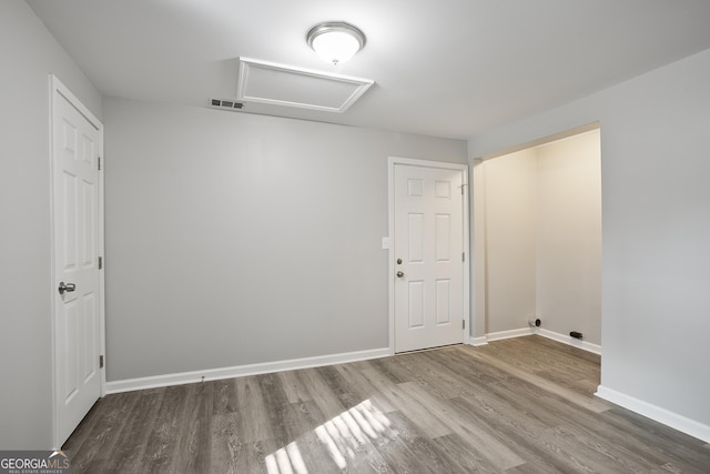 unfurnished room featuring hardwood / wood-style flooring