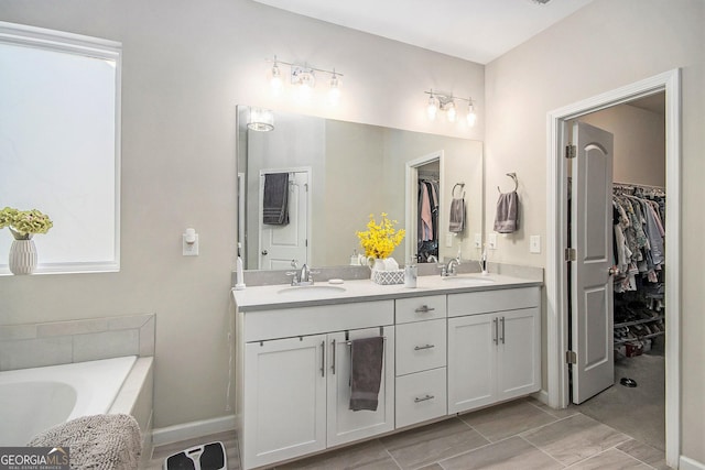 bathroom with vanity and a tub to relax in