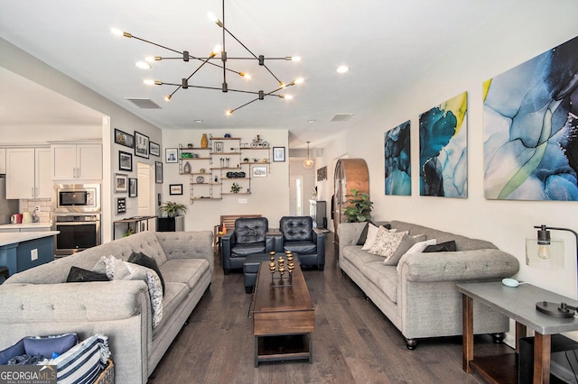 living room featuring dark hardwood / wood-style floors and a notable chandelier