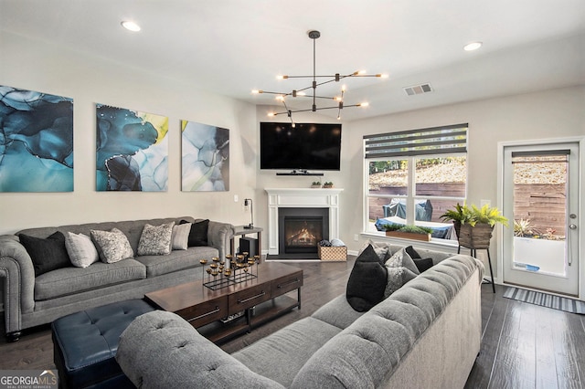 living room featuring a chandelier and dark hardwood / wood-style floors