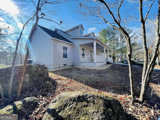 view of property exterior featuring a porch and central air condition unit