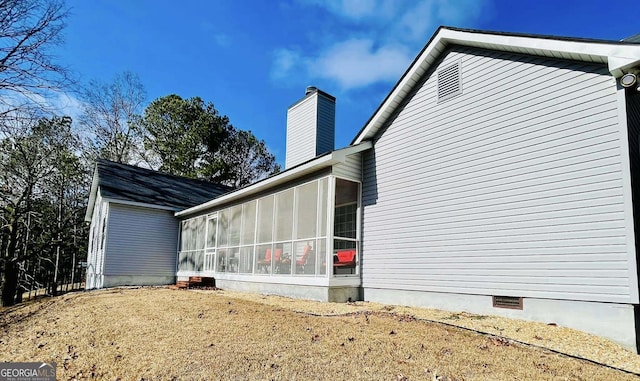 view of property exterior with a sunroom and a yard