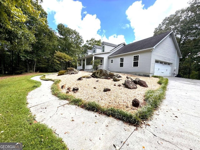 view of side of home with a garage and a yard