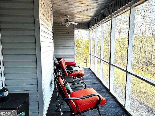 sunroom with a healthy amount of sunlight and ceiling fan