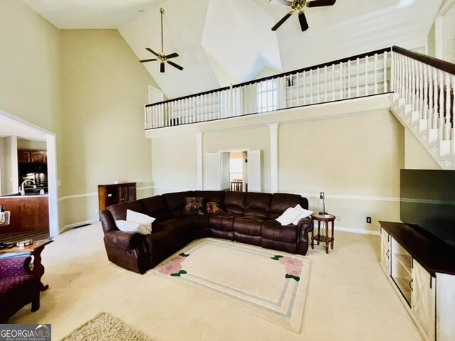 living room with high vaulted ceiling, carpet flooring, and ceiling fan