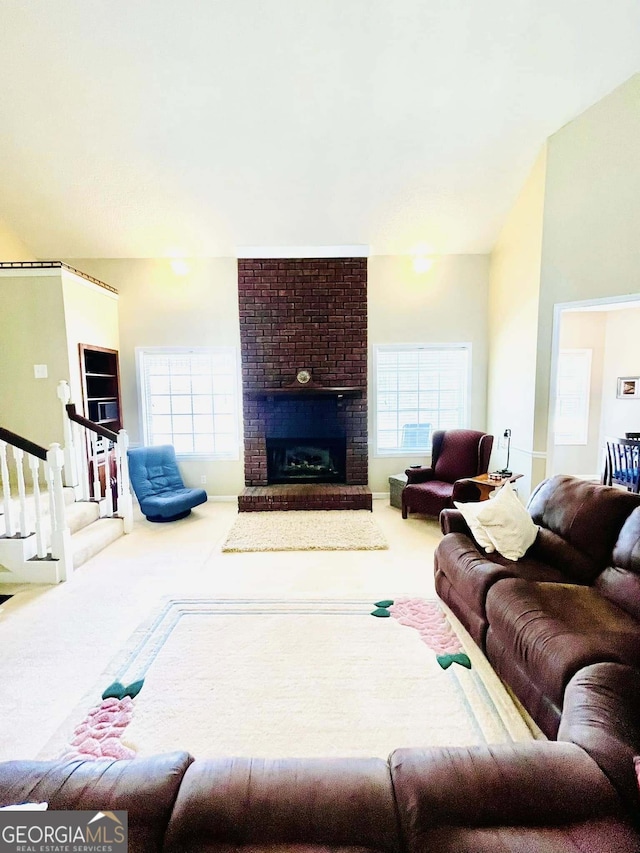 living room featuring carpet, lofted ceiling, and a fireplace