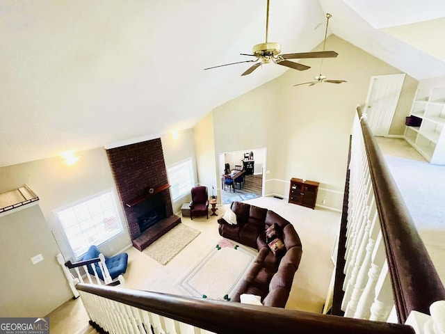 living room featuring a brick fireplace, light carpet, and high vaulted ceiling