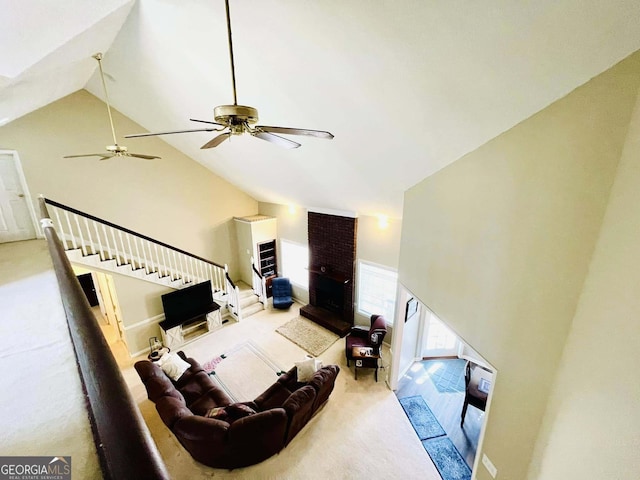 carpeted living room with high vaulted ceiling